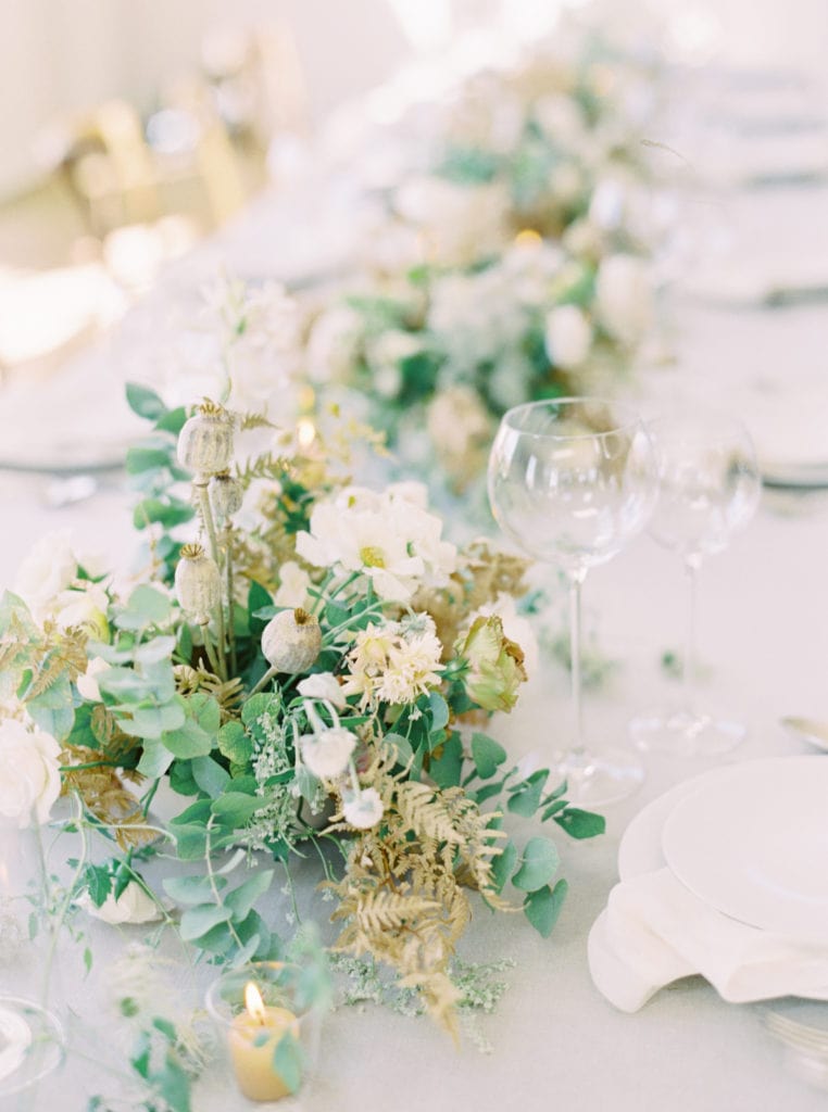 Close-up shot of the elegant floral arrangements set up on the wedding reception table