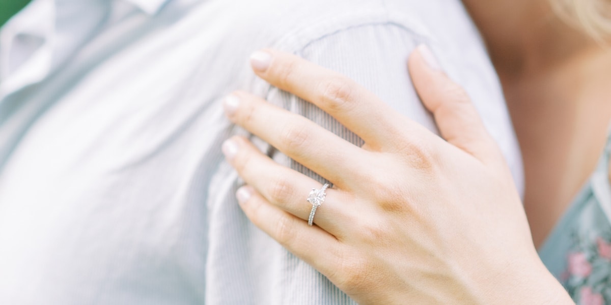 Engagement ring on bride-to-be in an engagement shoot