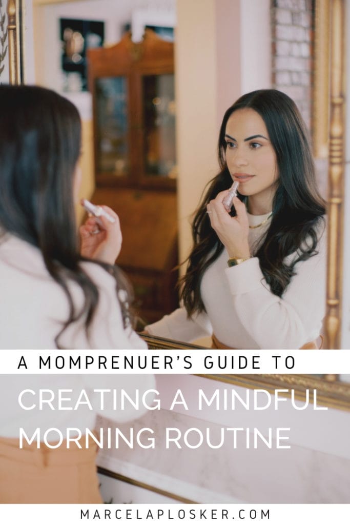 A momprenuer putting on lipstick in the mirror with the caption "A Momprenuer's Guide to Creating a Mindful Morning Routine." Photographed by North Shore, Massachusetts wedding photographer Marcela Plosker