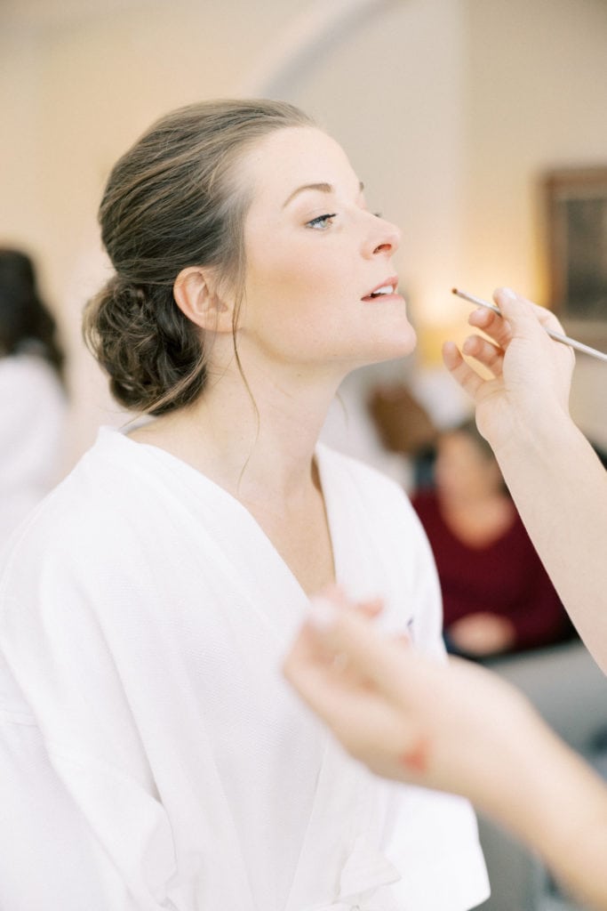 A momprenuer starting her mindful morning routine by putting on makeup. Photographed by North Shore, Massachusetts wedding photographer Marcela Plosker