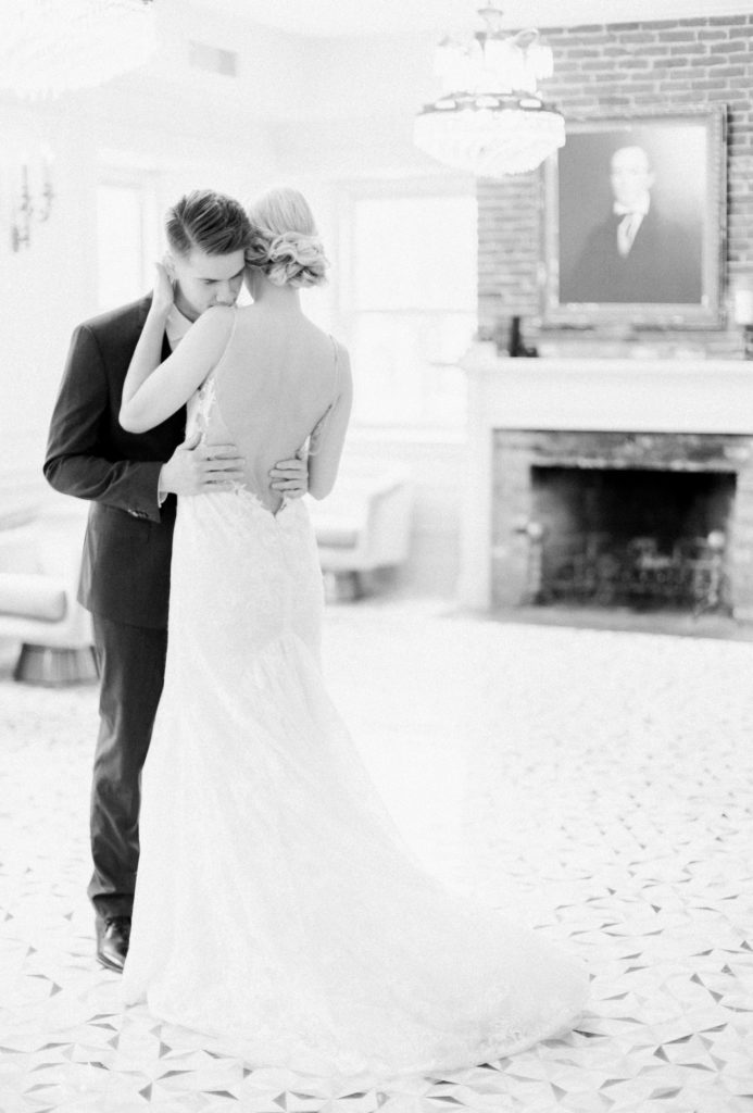 A couple embraces while doing an intimate first look on their wedding day. Photographed by Marcela Plosker, a Boston wedding photographer.
