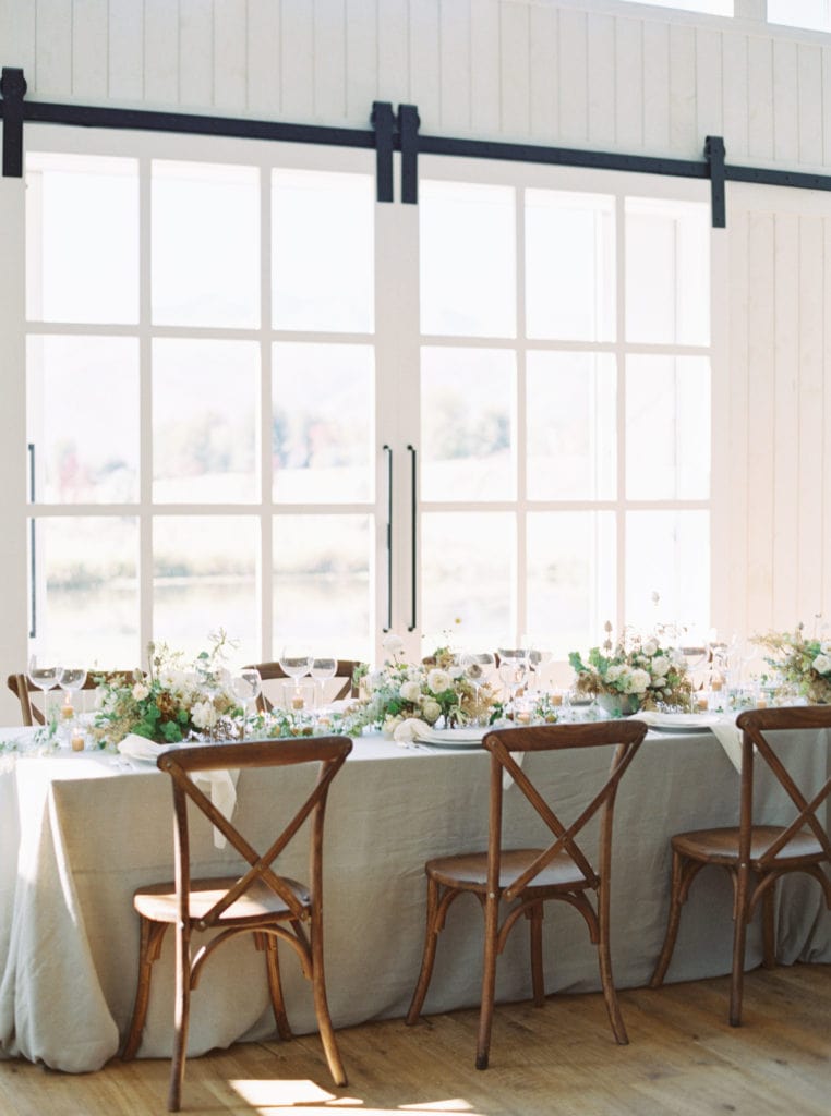 The tablescape of a wedding reception with lush floral centerpieces. Must-have wedding photos by Marcela Plosker, a Boston wedding photographer.