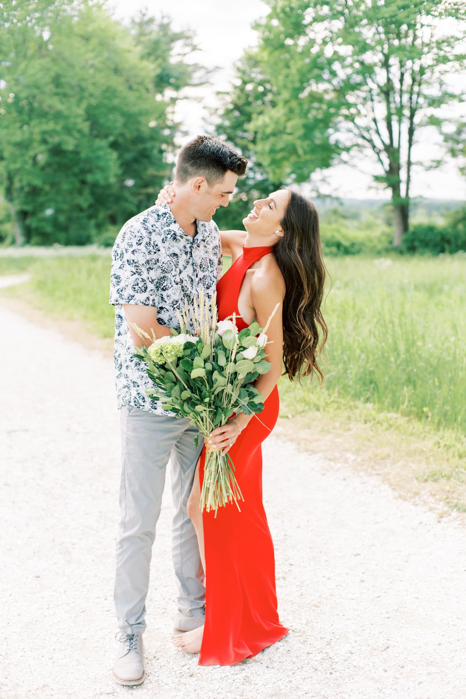 Bride to be embraces groom to be during their engagement shoot as an example of a fine art engagement photo idea by Boston wedding and engagement photography Marcela Plosker.