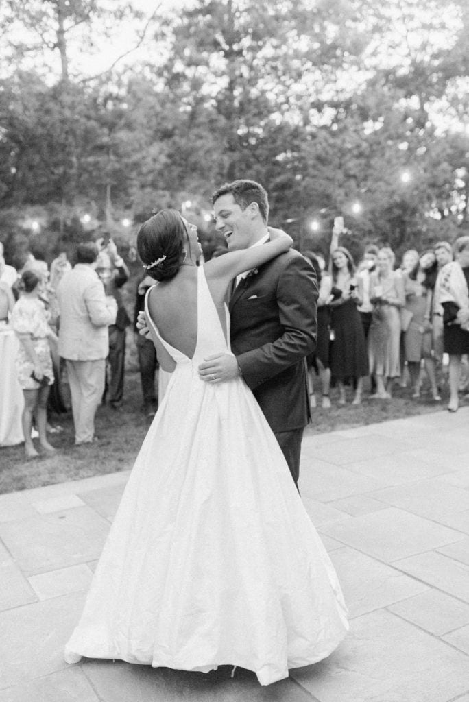 A candid image of a couple dancing and laughing during their wedding reception as an example of a wedding photography style by Marcela Plosker, a Massachusetts wedding photographer.