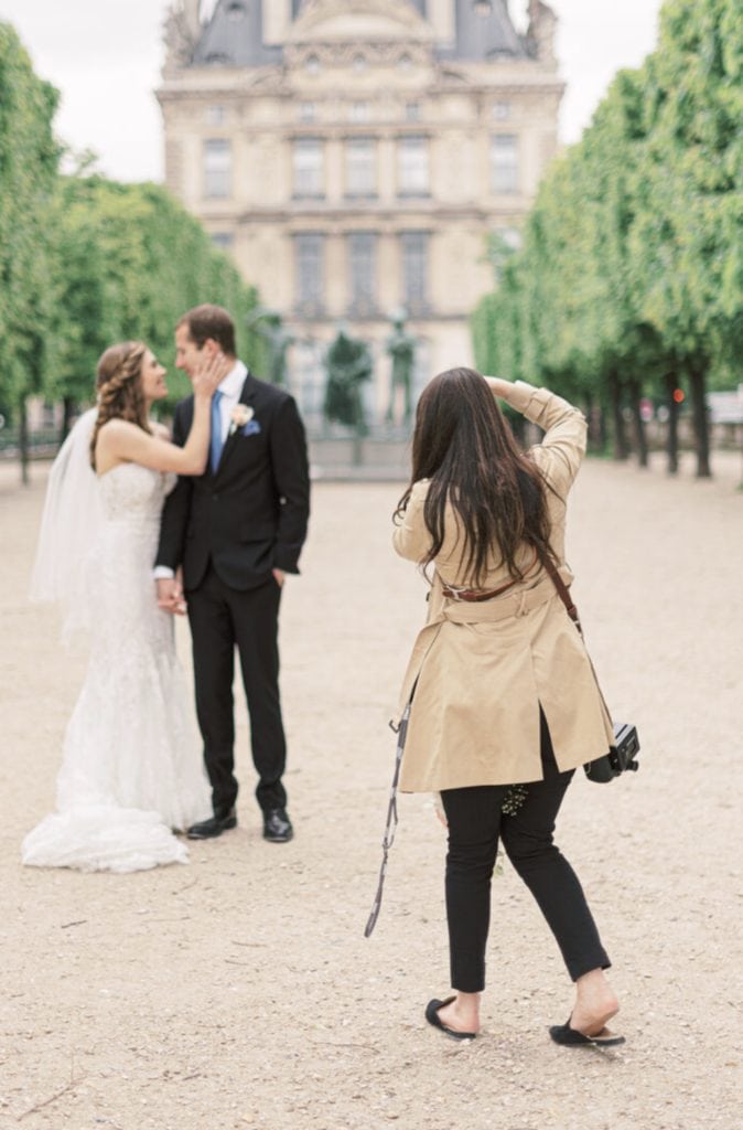 Marcela Díaz takes an image of a couple posing during their wedding