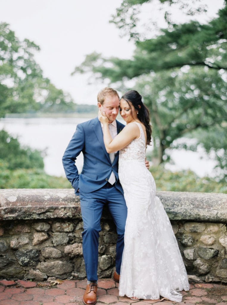 10 Dreamy Mansion Wedding Venues in New England: The Bride embracing the Groom outside of their New England wedding venue